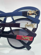 Blue eyeglass frame with gold logo temple and bar detail