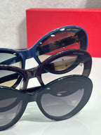 Blue cat-eye eyeglasses with gold logo temple emblem detail