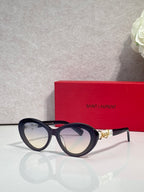 Navy round eyeglasses with gold logo temple accents