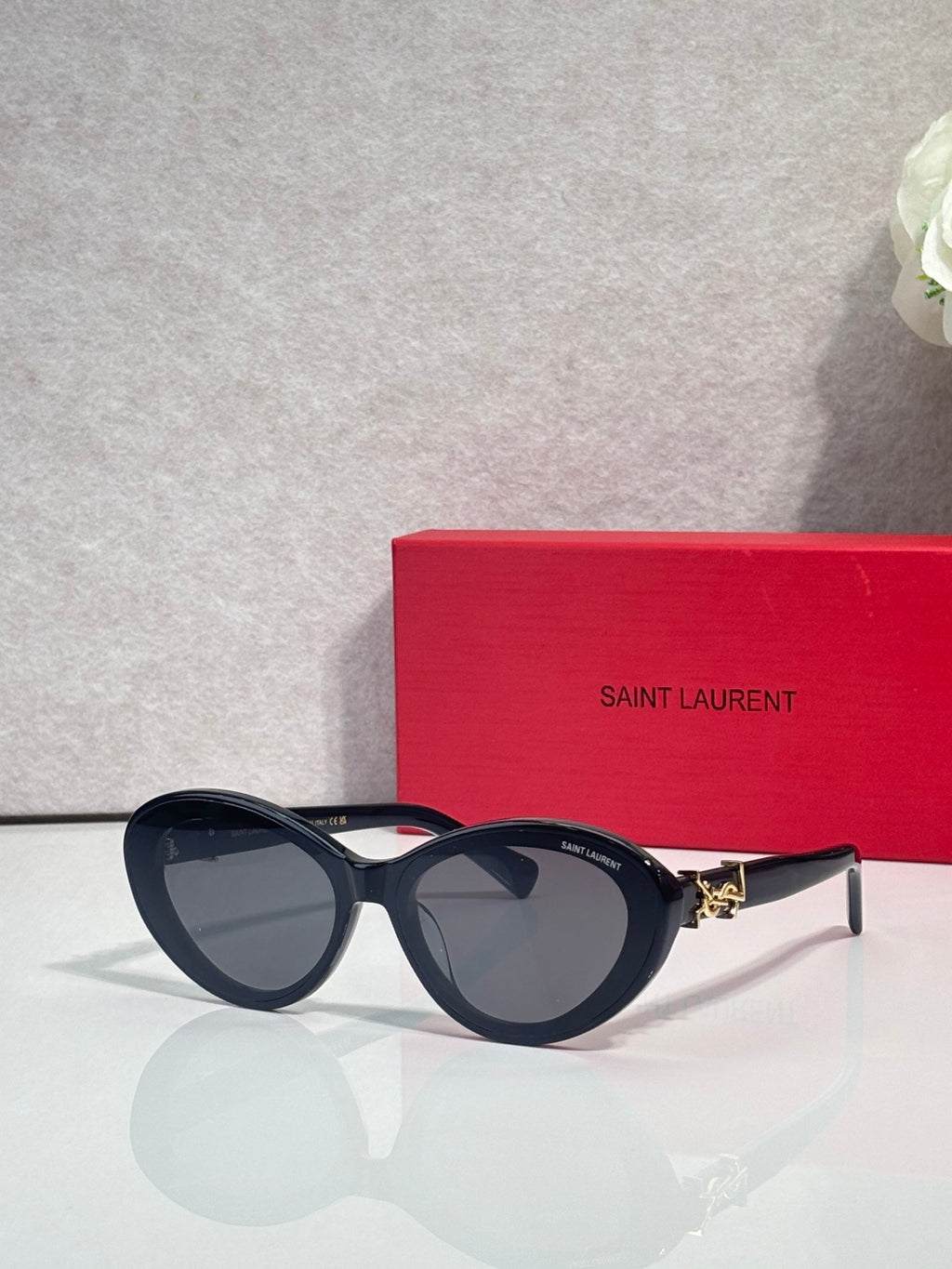 Dark blue round eyeglasses with gold logo temple accents