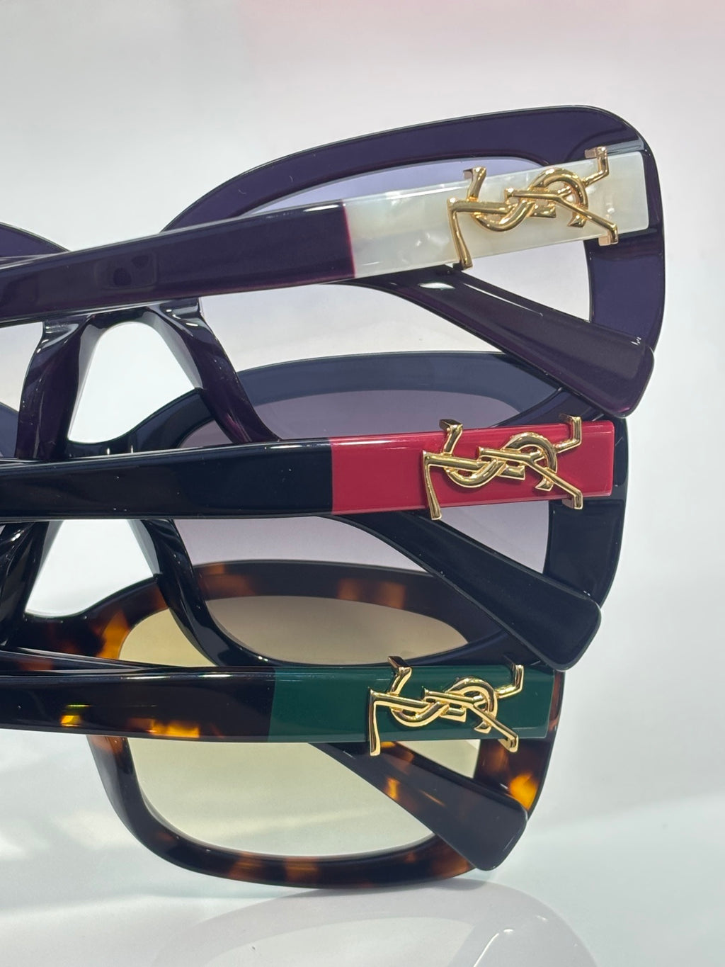 YSL sunglasses temple with gold logo detail on dark frames