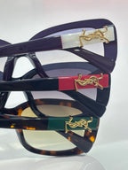 YSL sunglasses temple with gold logo detail on dark frames