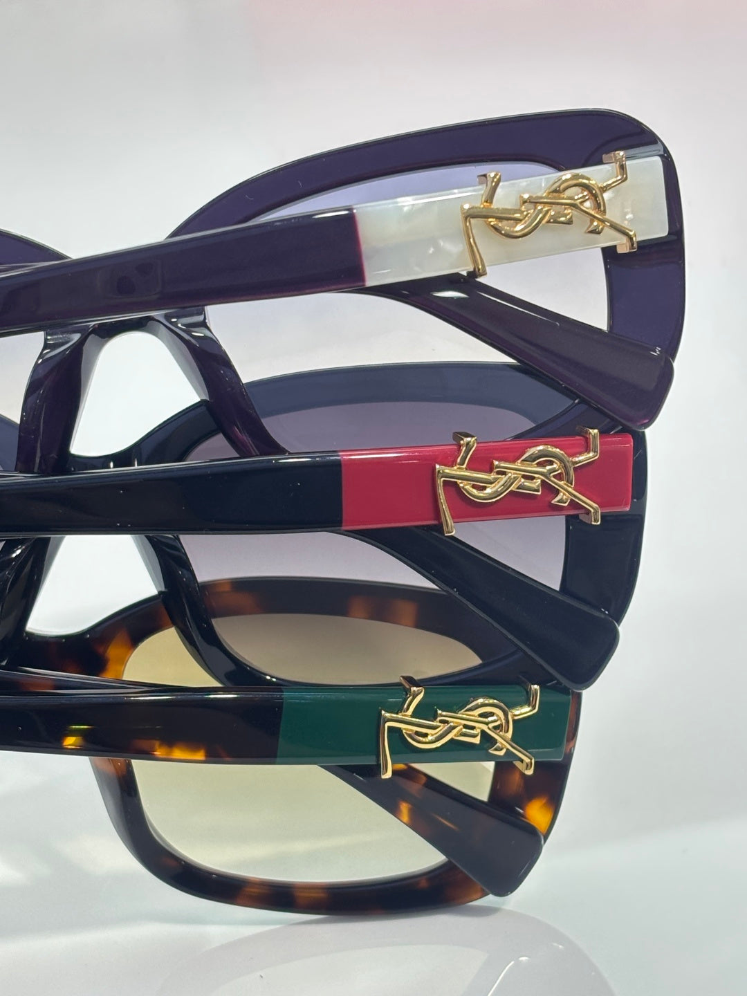 YSL sunglasses temple with gold logo detail on dark frames