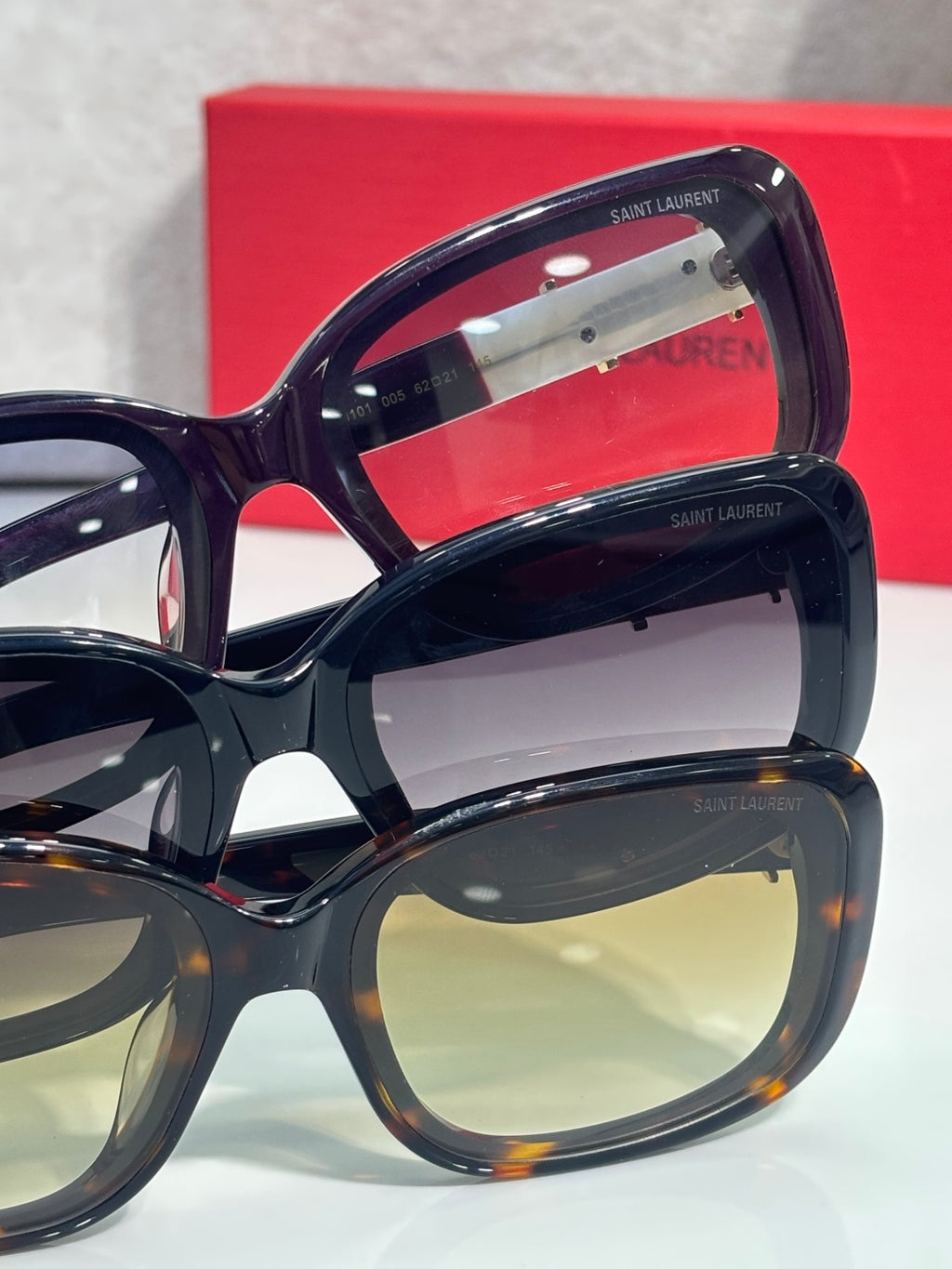 YSL sunglasses close-up with dark lenses and gold logo on frames