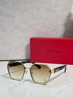 YSL glasses with gold frame and pale yellow tinted lenses, cat-eye silhouette