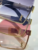 Close-up of rectangular sunglasses with navy gradient lens and gold YSL logo frame