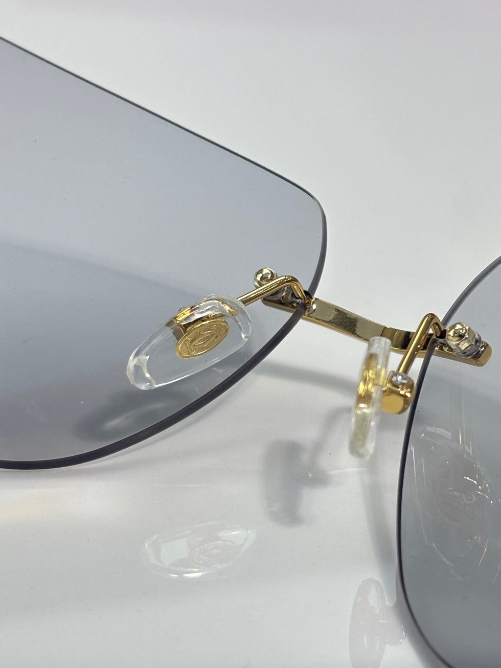 Cartier glasses close-up of gold-tone hinge and clear lens edge