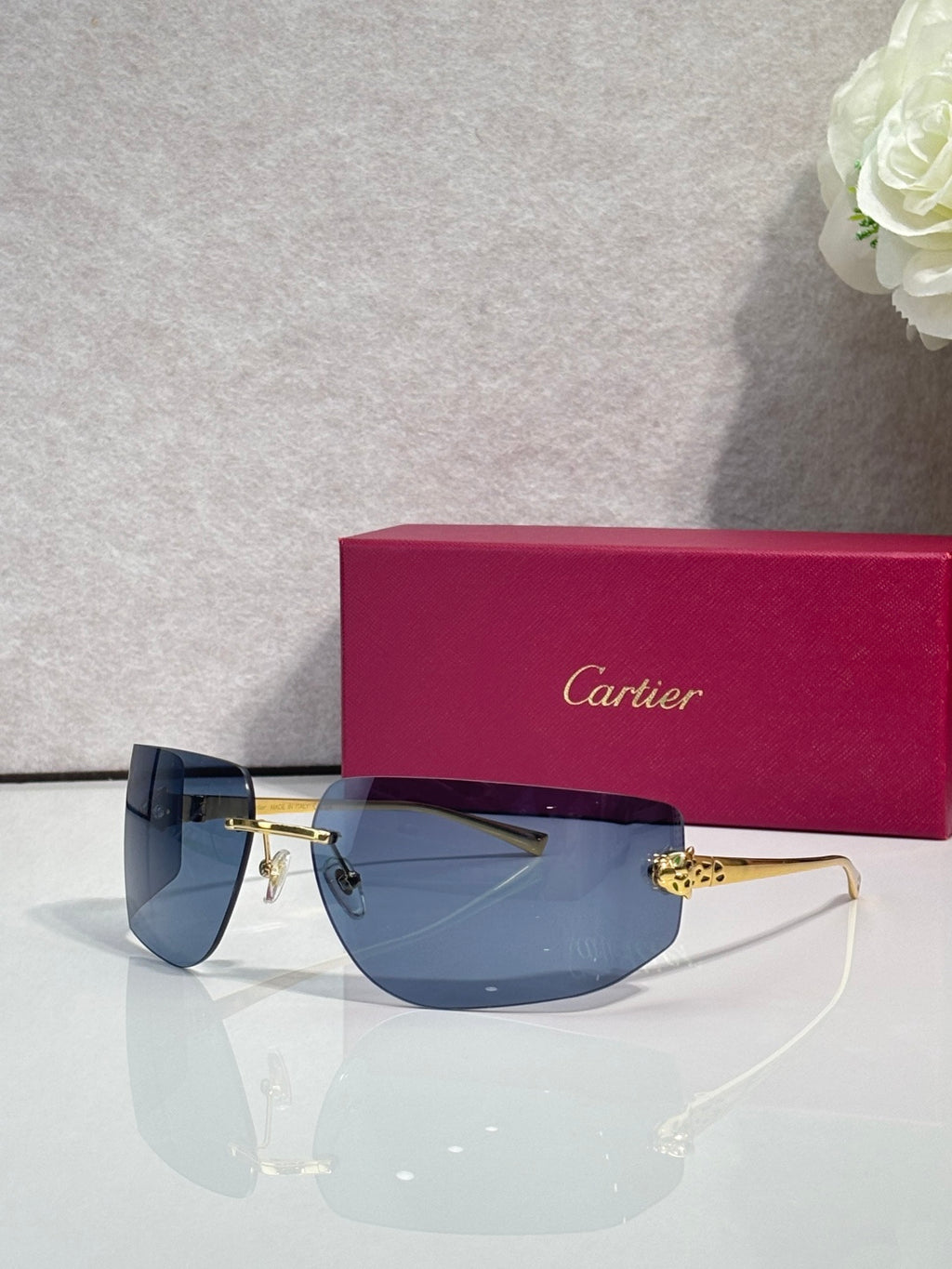 Cartier sunglasses with blue-tinted gradient lenses and gold-tone metal frame
