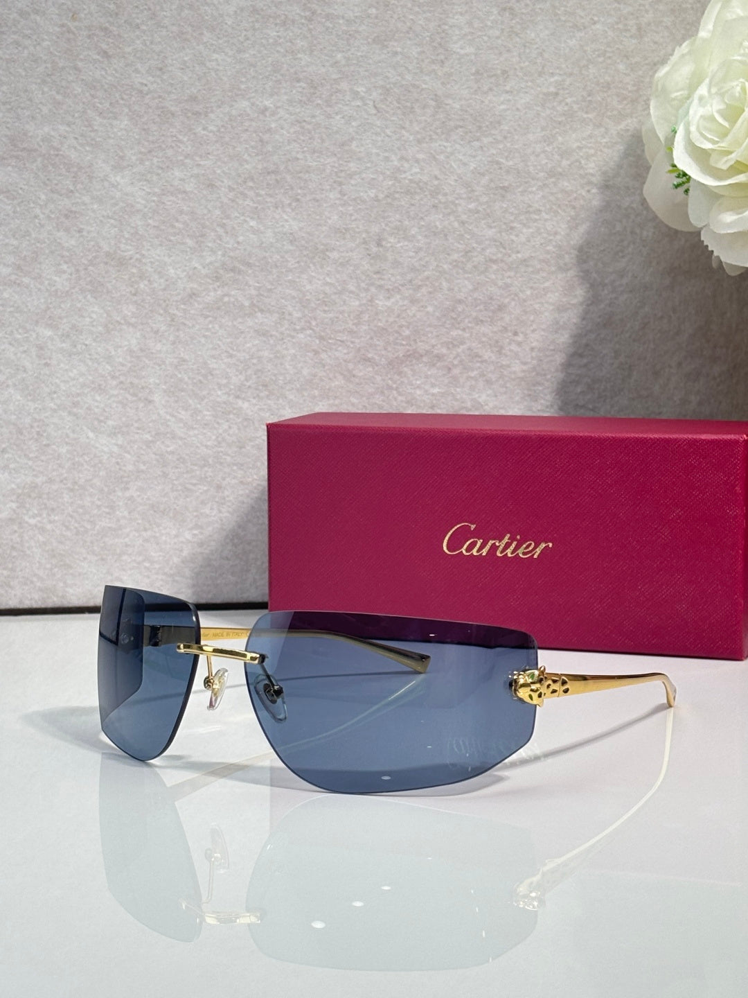 Cartier sunglasses with blue-tinted gradient lenses and gold-tone metal frame