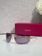 Cartier sunglasses with dark purple gradient lenses and gold-tone metal frame