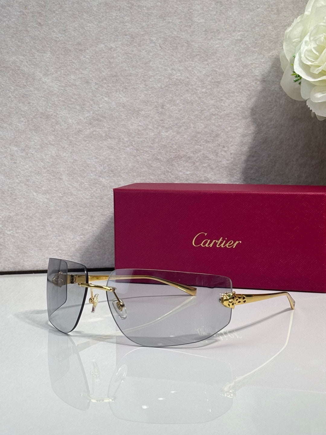 Cartier sunglasses with dark blue gradient lenses and gold-tone metal frame
