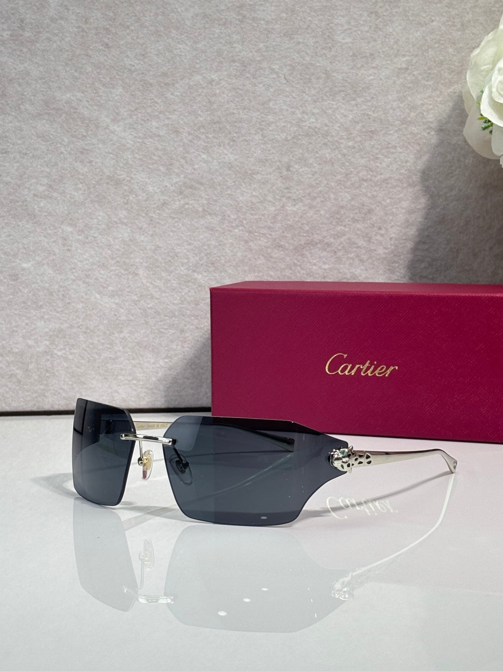 Cartier square sunglasses with dark lenses and gold-tone arms, side view