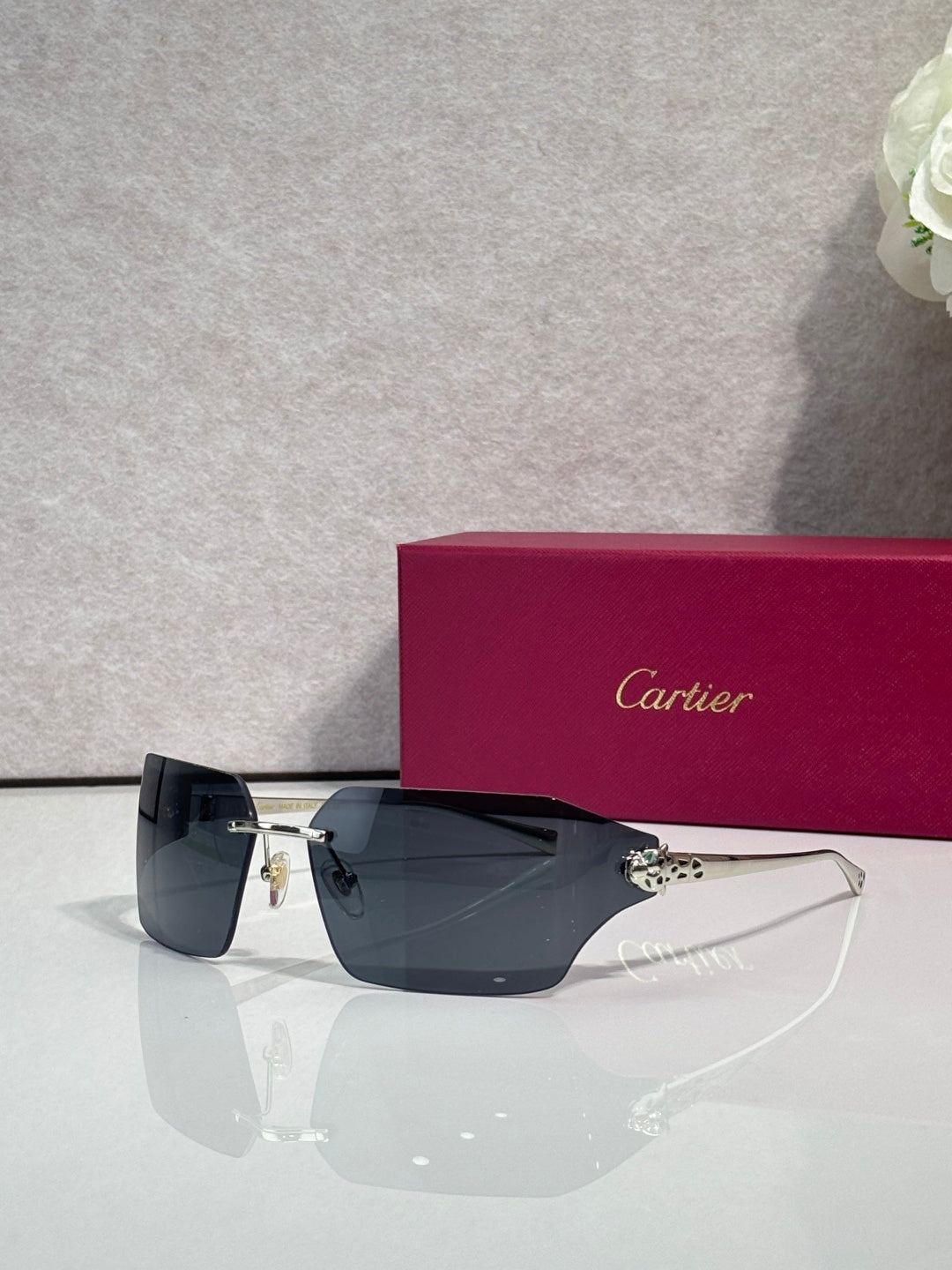 Cartier square sunglasses with dark lenses and gold-tone arms, side view