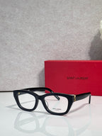 Black and tortoise eyeglasses with clear lenses, sculpted frame, and gold-tone hinges