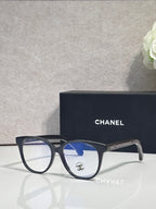 Chanel eyeglasses with dark frames and blue-tinted lenses