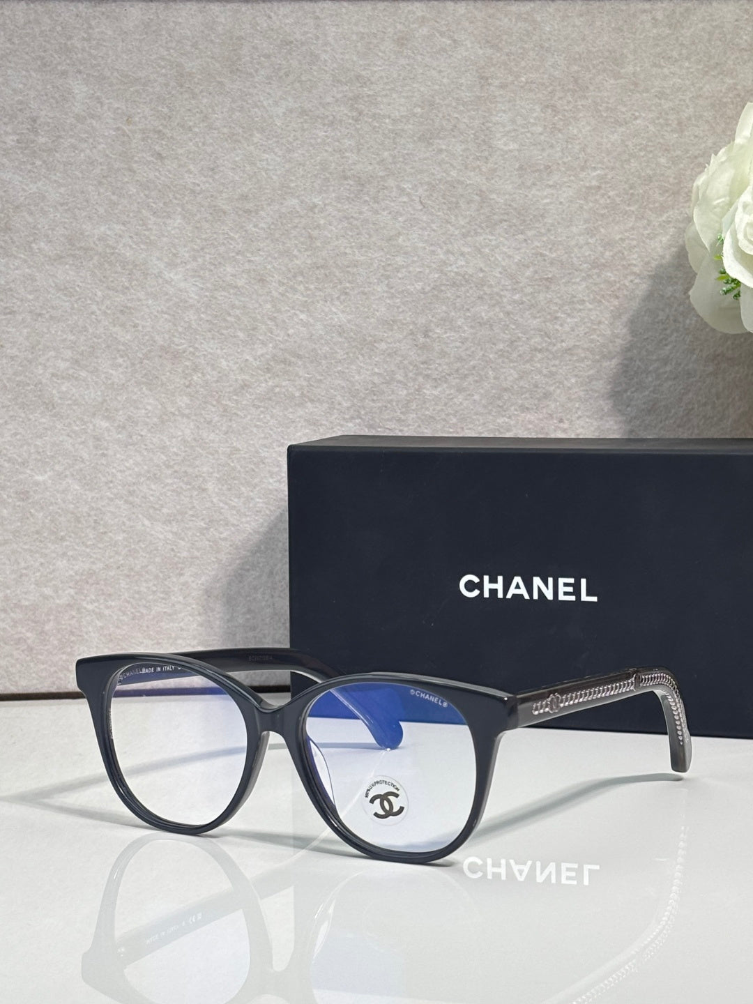 Chanel eyeglasses with dark frames and blue-tinted lenses