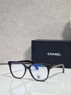 Chanel eyeglasses with black round frames and blue-tinted lenses