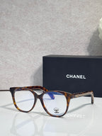 Chanel eyeglasses with tortoiseshell round frames and clear lenses