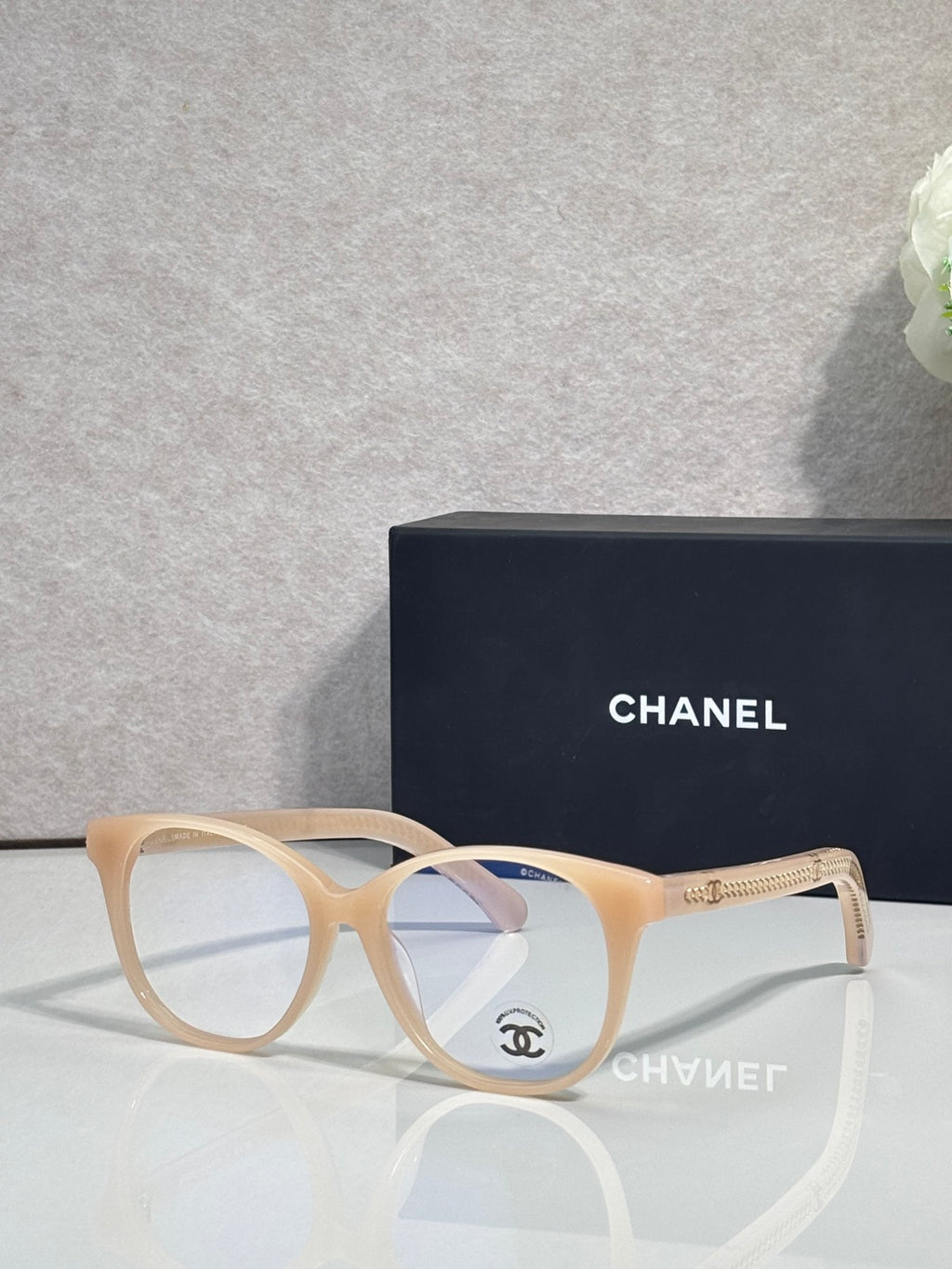 Chanel eyeglasses with cream round frames and clear lenses