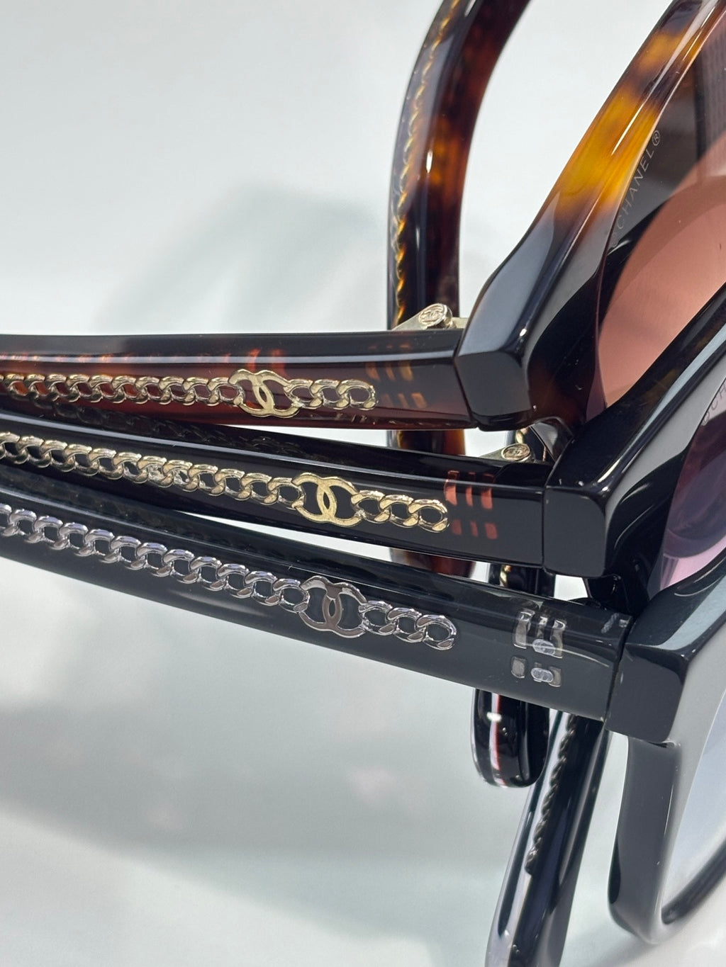 Chanel eyeglass temple with gold-tone chain detail and logo