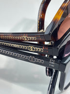 Chanel eyeglass temple with gold-tone chain detail and logo