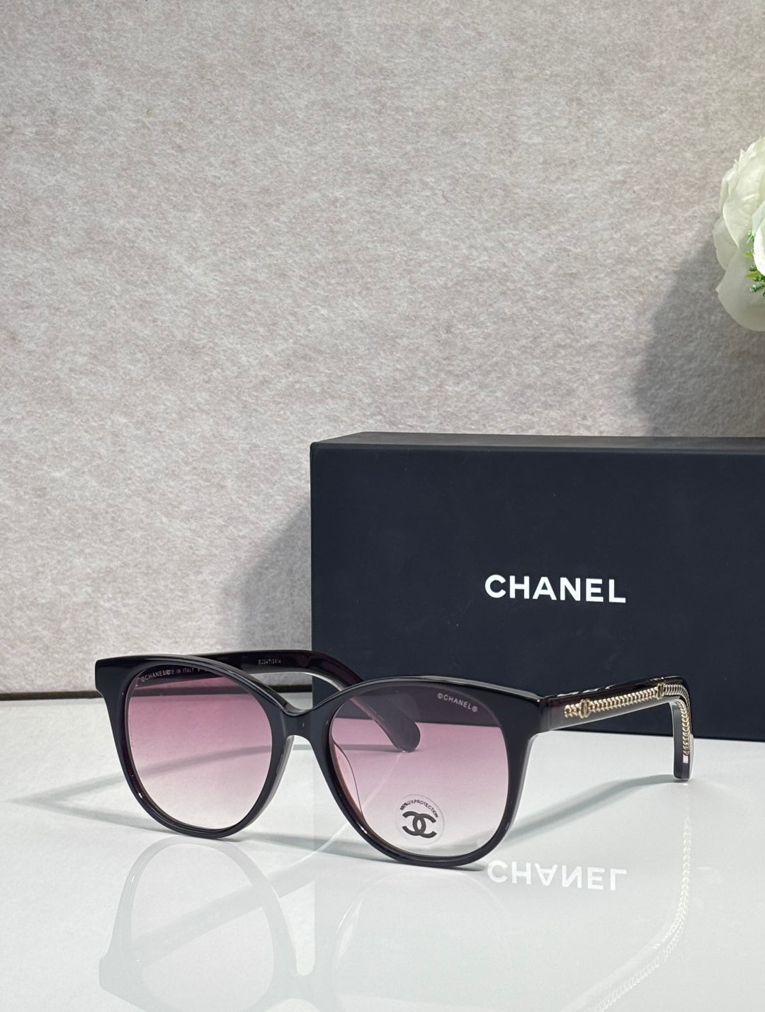 Chanel glasses with dark frames and rose tinted lenses