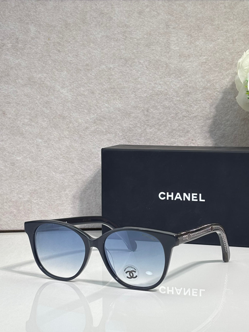 Chanel glasses with dark blue frames and blue tinted lenses