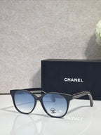 Chanel glasses with dark blue frames and blue tinted lenses