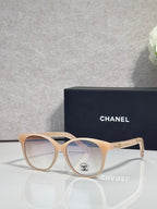 Chanel glasses with light beige frames and clear tinted lenses