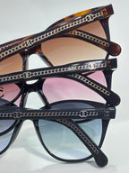 Chanel glasses with dark frames, round lenses, and chain-detailed temples