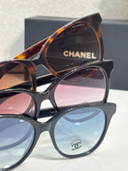 Chanel glasses with tortoiseshell top frame and black bottom frame, tinted lenses