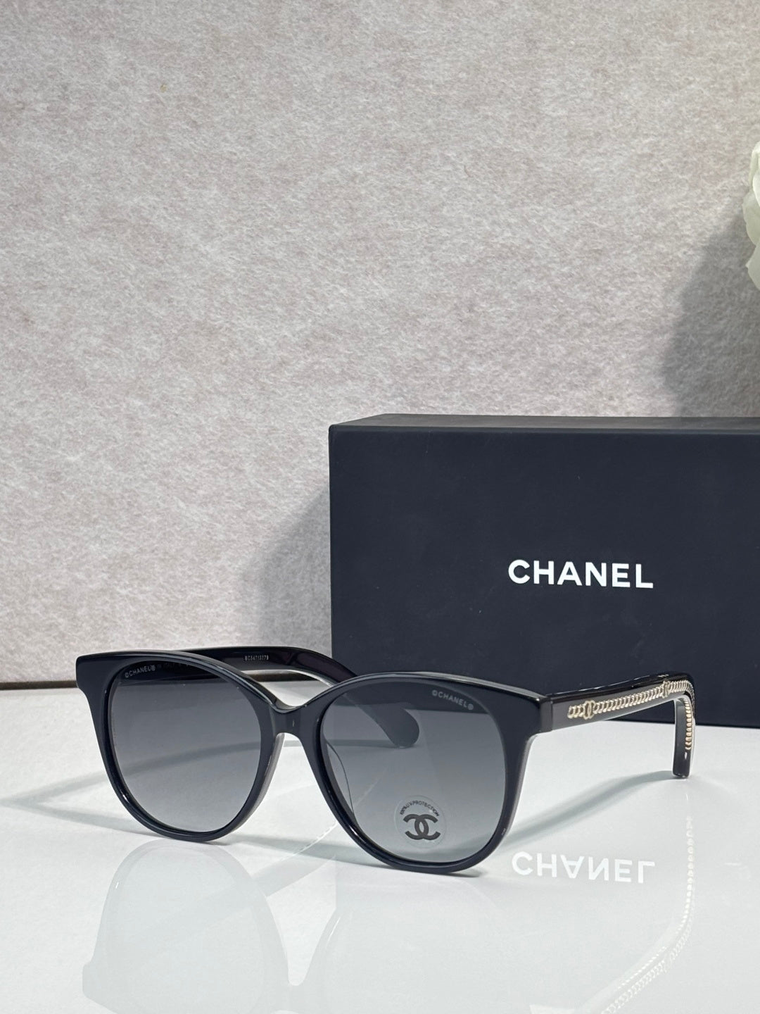 Chanel glasses with black frames and gray tinted lenses