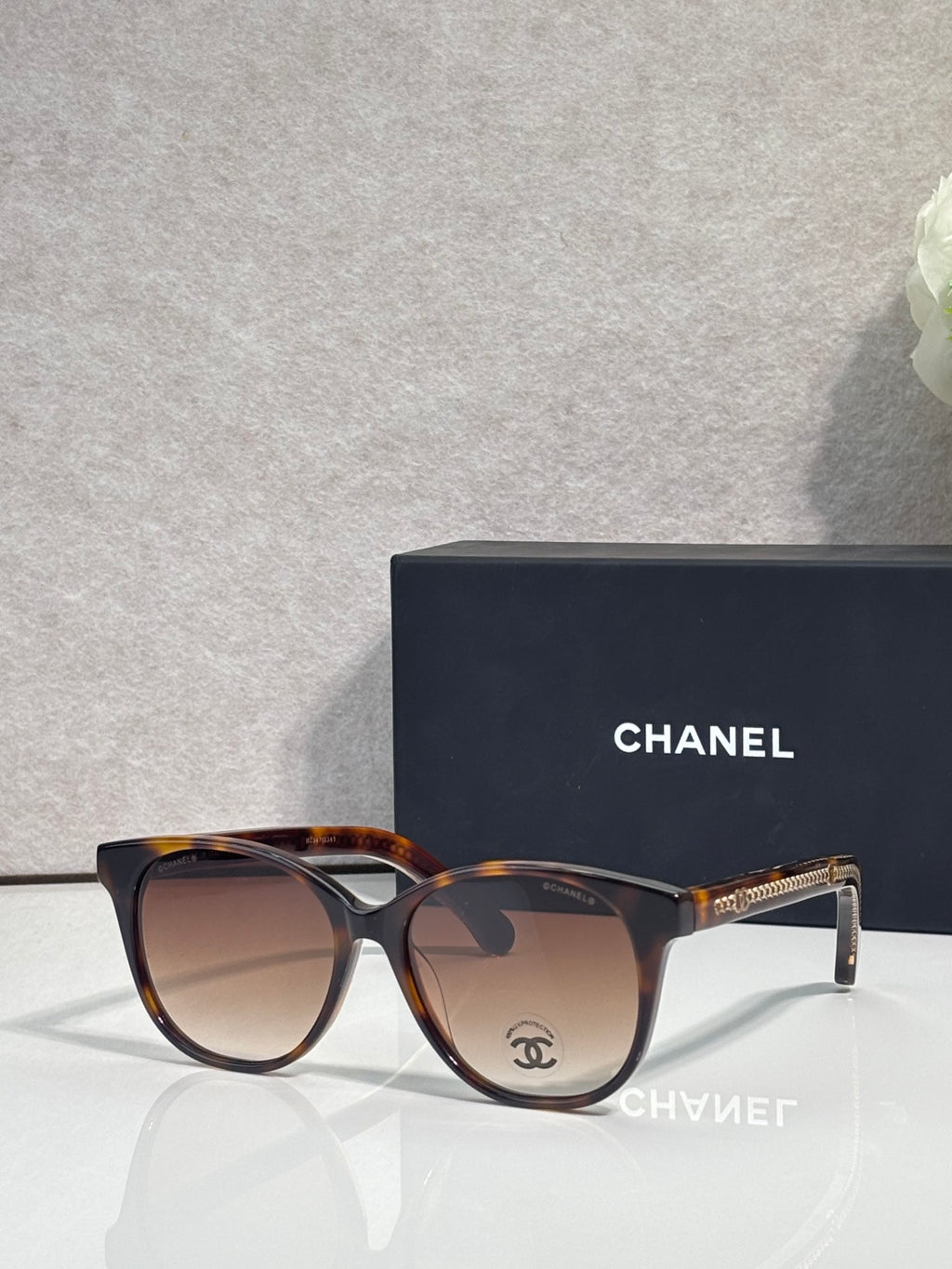 Chanel glasses with tortoiseshell frames and warm brown lenses