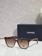 Chanel glasses with tortoiseshell frames and warm brown lenses