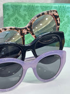 Gucci cat-eye sunglasses set: purple, black, and tortoiseshell frames with GG details.