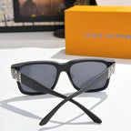 Louis Vuitton sunglasses front view with black frame, dark lenses, patterned side panels.