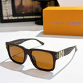 Louis Vuitton sunglasses with black frame, amber lenses, logo-pattern temple details.