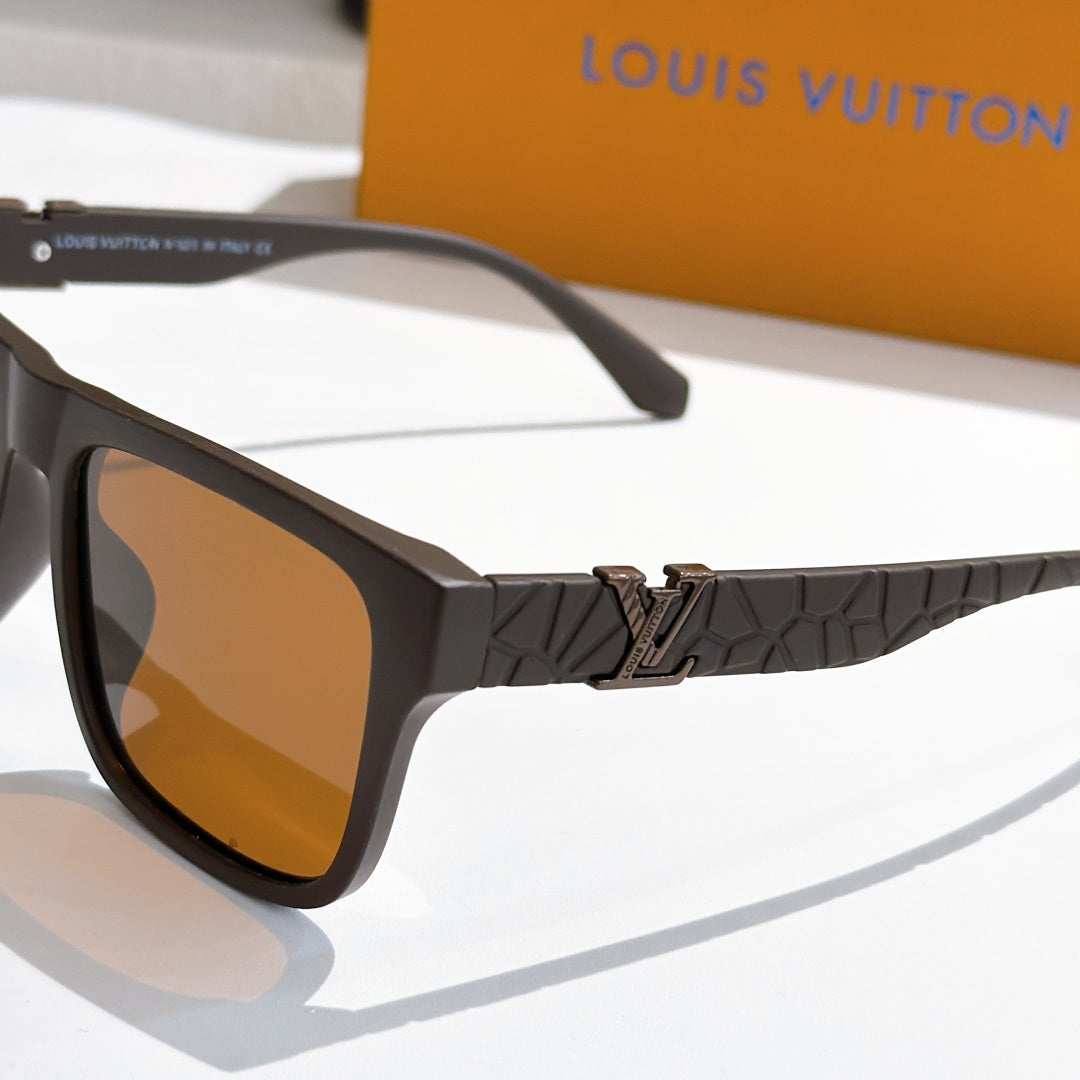 Louis Vuitton sunglasses close-up with dark frame, amber lenses, and textured patterned arm