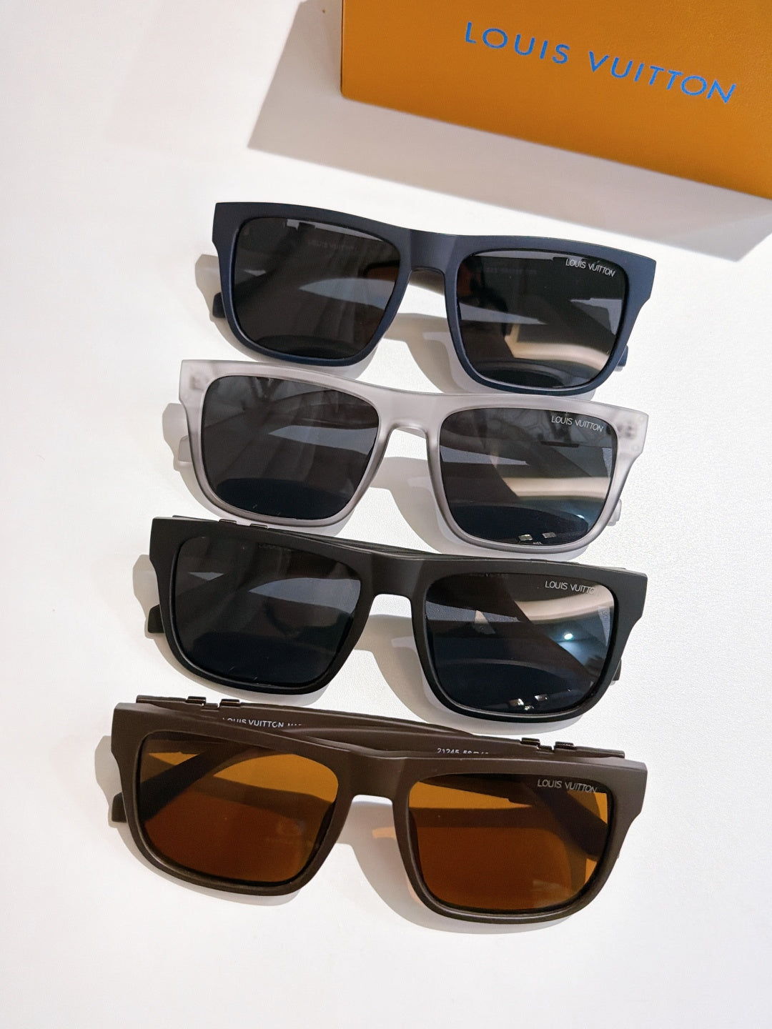 Louis Vuitton sunglasses set with black, gray, and brown frames, tinted lenses