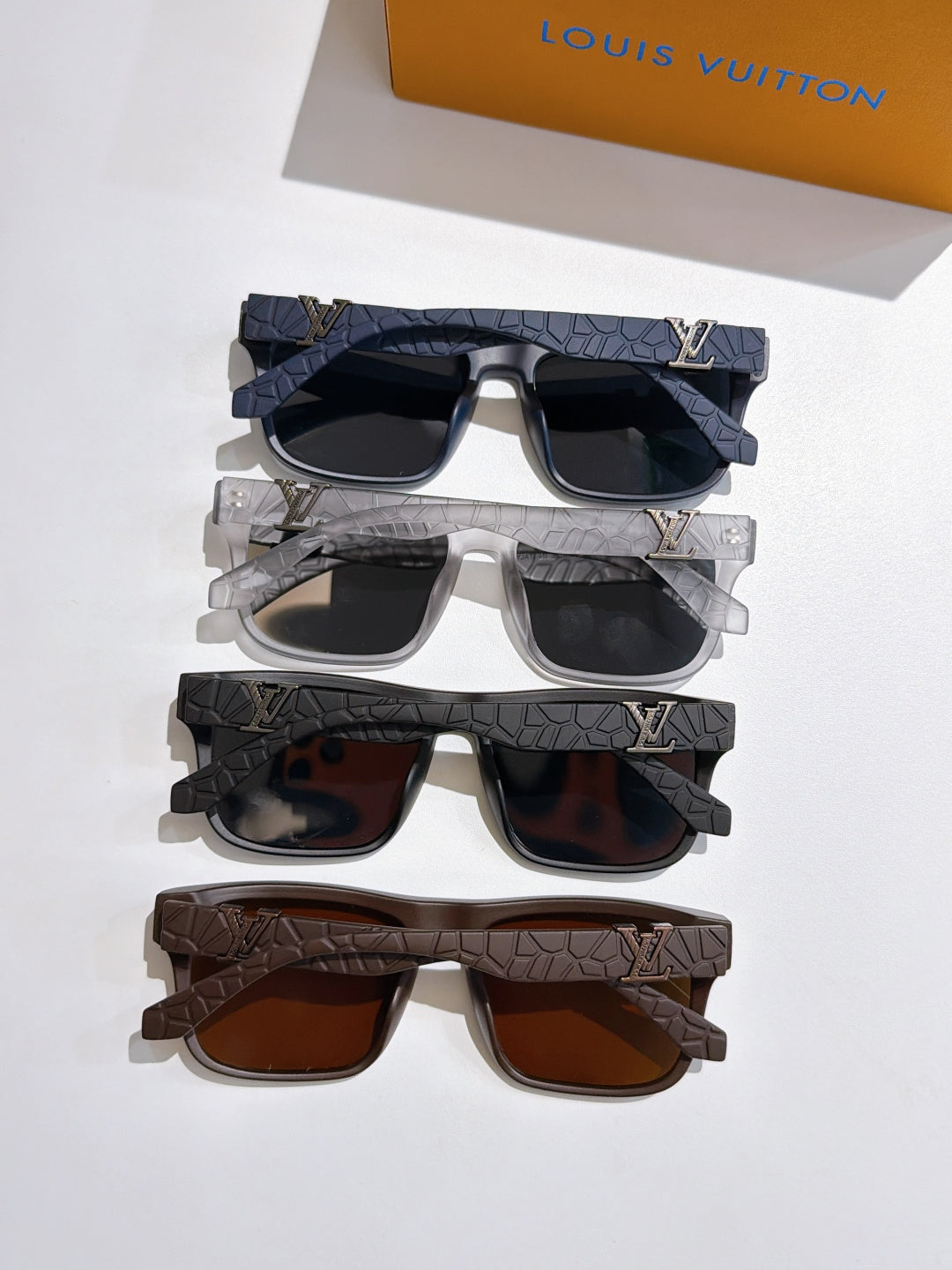 Louis Vuitton sunglasses set with black, silver, and brown frames, tinted lenses