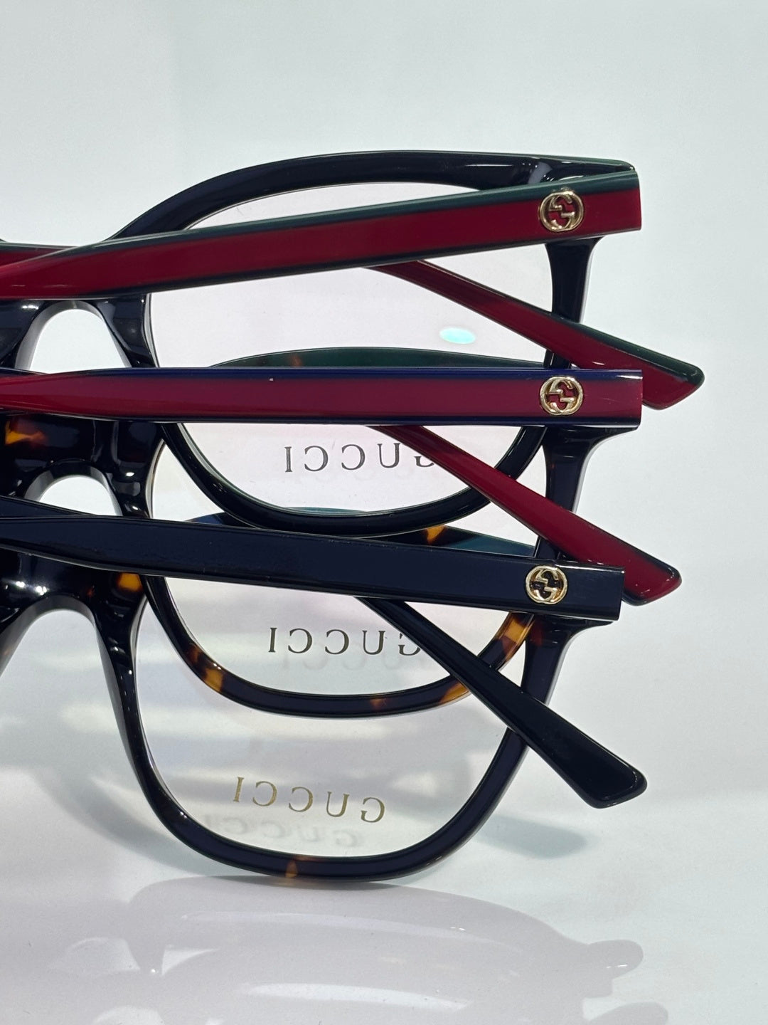 Eyeglasses frames in black with burgundy bars, clear lenses, stacked side view