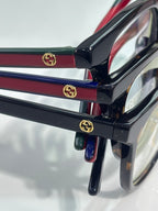 Black and burgundy eyeglasses with GG logo hinge detail and clear lens