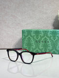 Gucci eyeglasses with black frames, clear lenses, and burgundy temple details
