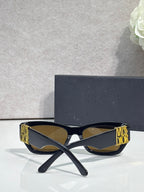 Sunglasses front view with dark navy square frames and gold logo on both temples