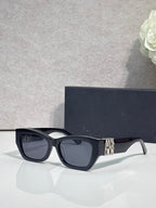 Sunglasses with dark navy frames and gold logo on side arm, tinted lenses