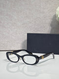 Black oval eyeglasses with clear lenses and gold-tone hinge hardware