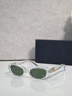 Clear white oval eyeglasses with dark lenses and gold-tone accents
