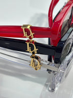 Dior logo on red and clear eyeglasses frame bar with gold-tone hardware