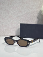 Black oval eyeglasses with dark lenses and silver-tone temples
