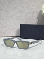 Dior black eyeglasses with green-tinted lenses and metal logo hinge